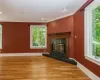 Unfurnished living room featuring light hardwood / wood-style flooring, a fireplace, and crown molding