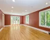 Unfurnished room featuring a healthy amount of sunlight, light hardwood / wood-style flooring, and crown molding