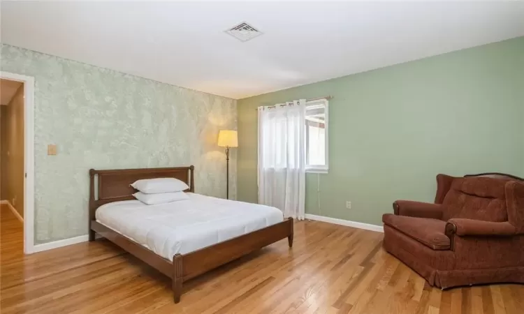 Bedroom with hard wood flooring