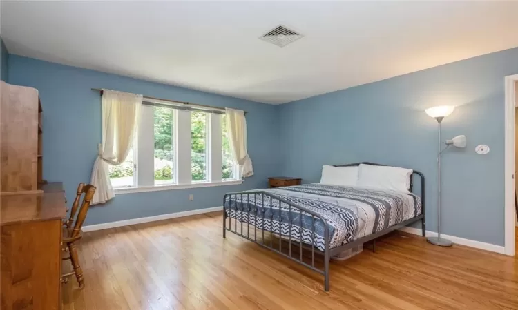 Bedroom with light hardwood / wood-style flooring