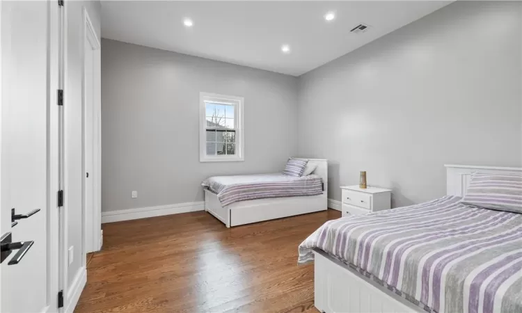 Bedroom with wood-type flooring