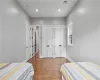 Bedroom with multiple closets and hardwood / wood-style floors