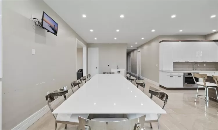 Tiled dining room with sink