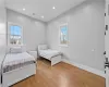 Bedroom with multiple windows and light wood-type flooring