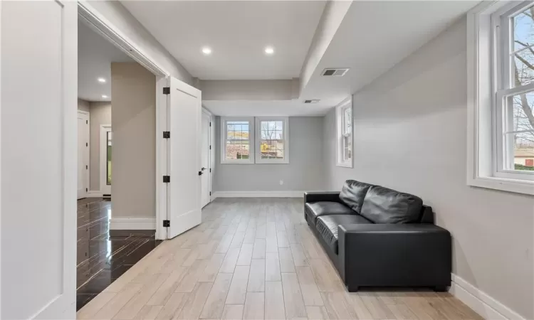 Sitting room featuring plenty of natural light and light hardwood / wood-style floors