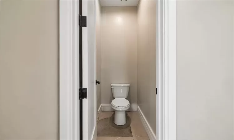 Bathroom featuring tile flooring and toilet