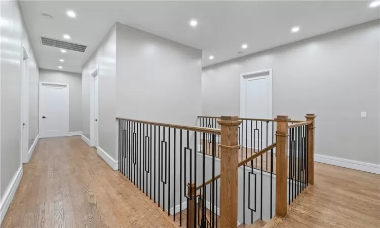 Hallway with light hardwood / wood-style floors