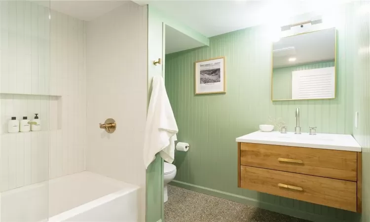 Full bathroom featuring oversized vanity, toilet, and tiled shower / bath combo