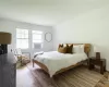 Bedroom featuring hardwood / wood-style flooring and lofted ceiling