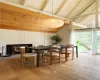 Dining space featuring lofted ceiling with beams and light hardwood / wood-style flooring