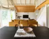 Dining room with beamed ceiling, wooden ceiling, hardwood / wood-style floors, a wall mounted air conditioner, and high vaulted ceiling