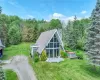 View of front of property featuring a sunroom and a front yard