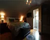 Bedroom with light wood-type flooring, vaulted ceiling, and ensuite bath