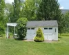 Garage featuring a lawn