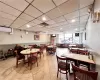 Dining space featuring light tile flooring, a paneled ceiling, and a wall mounted AC