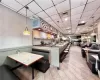 Kitchen featuring backsplash, a paneled ceiling, light tile flooring, and decorative light fixtures