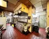 Kitchen featuring tile floors, range with two ovens, and a drop ceiling