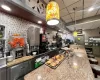 Kitchen with wine cooler, a paneled ceiling, and a kitchen bar