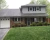 View of front of home with a garage and a front yard