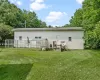 Rear view of property with a yard