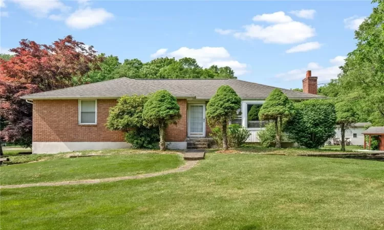 Ranch-style house with a front lawn