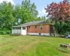 Rear view of house with a lawn