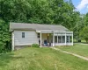 View of front of house featuring a front yard and a sunroom