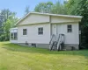 Back of property featuring a lawn