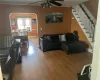 Living room with ceiling fan, ornamental molding, and hardwood / wood-style flooring