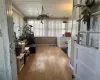 Mudroom/Entry porch w/ tons of light, wood-type flooring, and an inviting chandelier