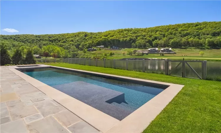 View of swimming pool with a lawn