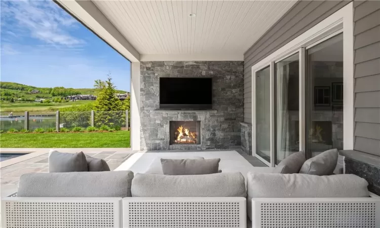 View of patio featuring an outdoor living space with a fireplace