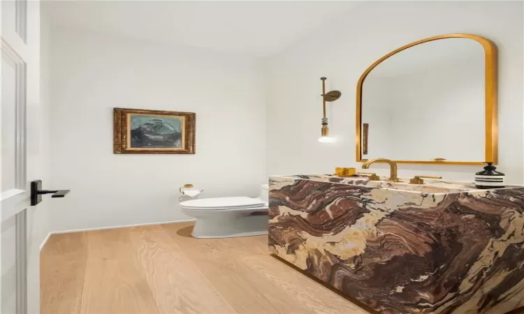 Bathroom with hardwood / wood-style floors and toilet