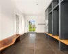 Mudroom featuring crown molding and dark tile flooring