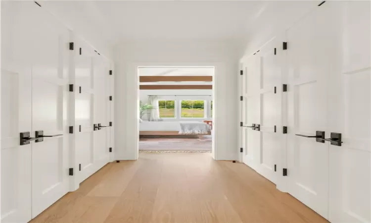 Corridor with light wood-type flooring