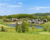 View of nearby features with a water view and a yard