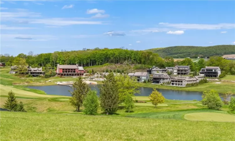 View of nearby features with a water view and a yard