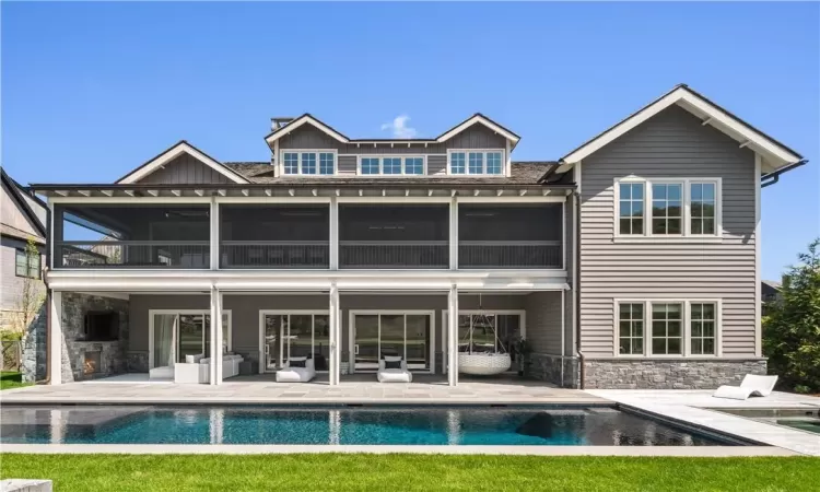 Back of property with a patio and a balcony