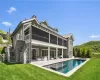 Rear view of house featuring a yard, a sunroom, an outdoor living space, and a patio area