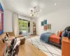 Bedroom with crown molding, an inviting chandelier, light hardwood / wood-style flooring, and access to exterior