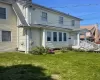 Back of house featuring a lawn