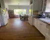 Kitchen featuring hanging light fixtures, white cabinetry, a baseboard radiator, and dark hardwood / wood-style floors