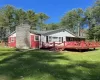 Deck front of home-covered porch in back blue stone chimney