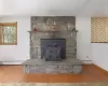 Living Room custom stone fireplace with woodstove insert.