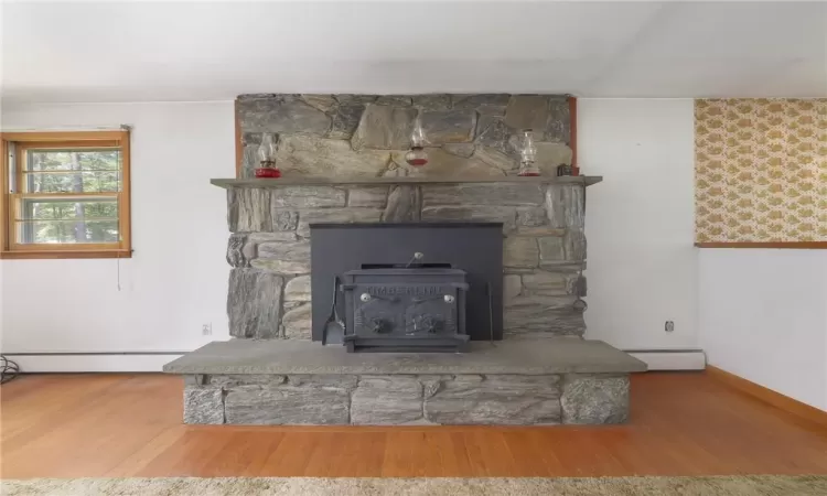 Living Room custom stone fireplace with woodstove insert.