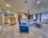 Living room featuring a baseboard radiator and light tile floors