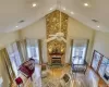 Living room with plenty of natural light, high vaulted ceiling, ceiling fan, and wood-type flooring