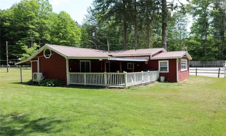 Back of house with an expansive lawn