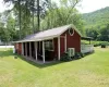 View of cottage with a nice level yard