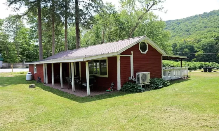 View of cottage with a nice level yard